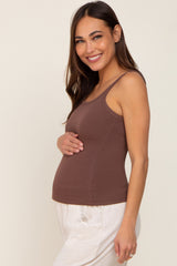 woman wearing a brown ribbed maternity tank top and holding her baby bump