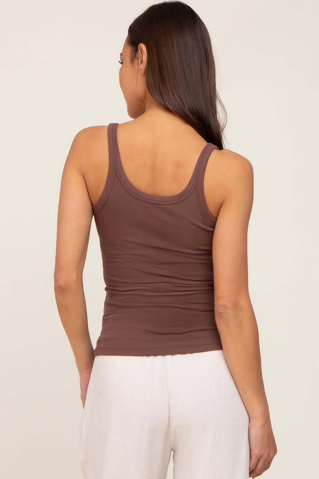 woman wearing a brown ribbed maternity tank top, showing the back view