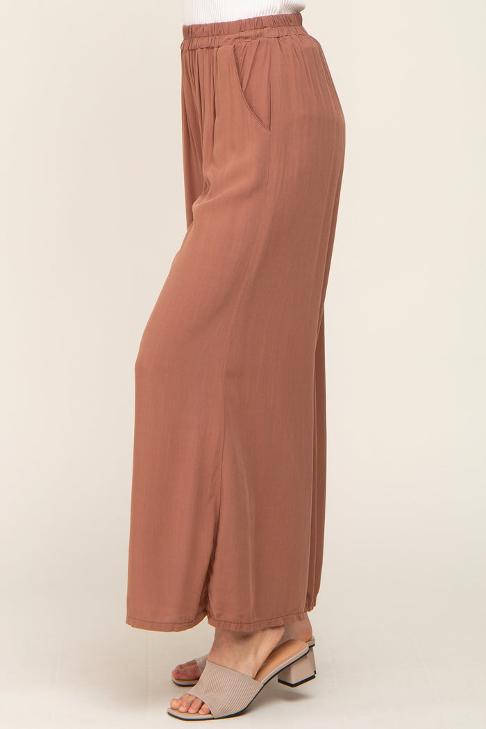 woman wearing mauve wide leg palazzo pants with elastic waistband and side pockets