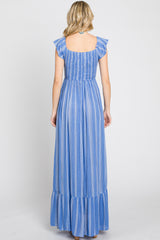 woman wearing a back view of a blue striped maxi dress with ruffle straps and a tiered skirt