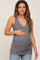 woman wearing a gray ribbed maternity tank top and holding her baby bump