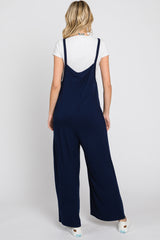 woman wearing a navy blue jumpsuit with wide legs and a relaxed fit, seen from the back