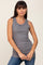 woman wearing a gray sleeveless ribbed tank top and blue jeans