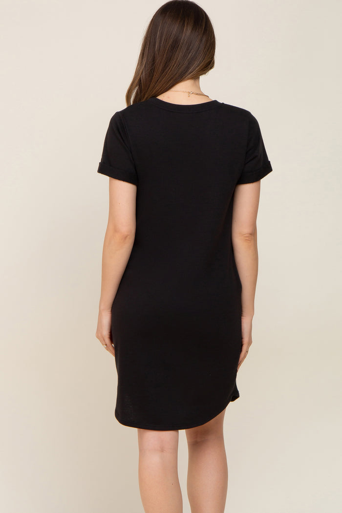 woman wearing a black short sleeve maternity dress, seen from the back