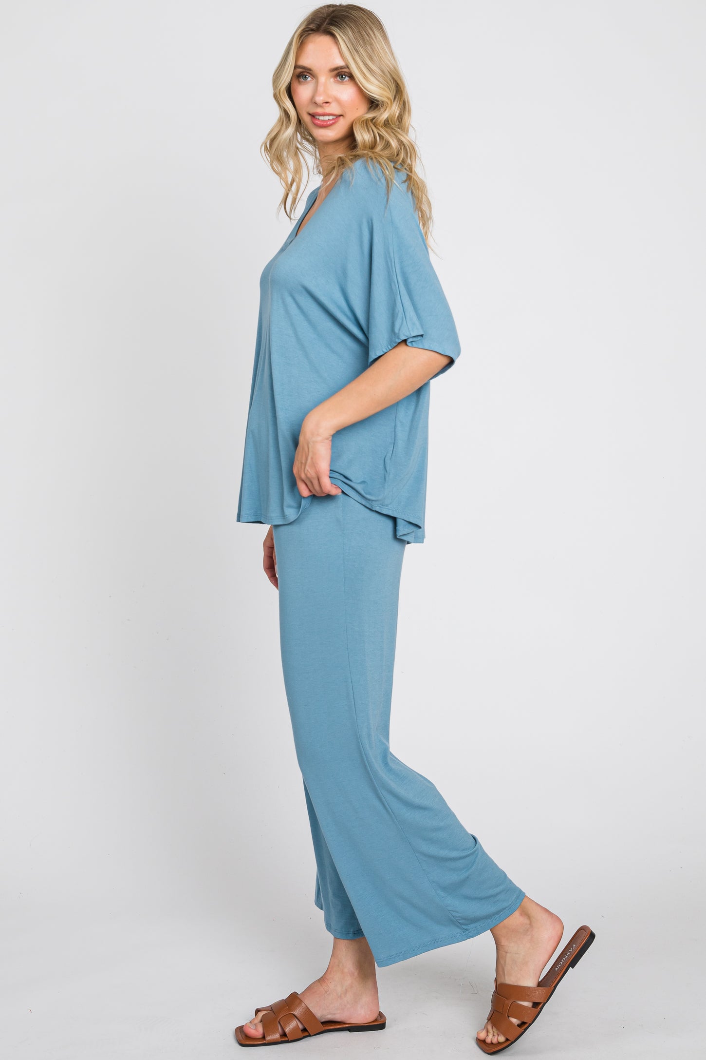 woman wearing a relaxed fit light blue lounge set with wide-leg pants and a loose short-sleeve top