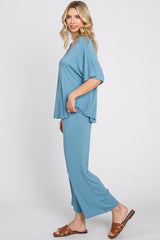 woman wearing a relaxed fit light blue lounge set with wide-leg pants and a loose short-sleeve top