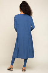 woman wearing a long blue ribbed tunic dress with a relaxed fit and paired with matching leggings