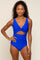 woman wearing a vibrant blue cut-out one-piece swimsuit with a twisted front detail