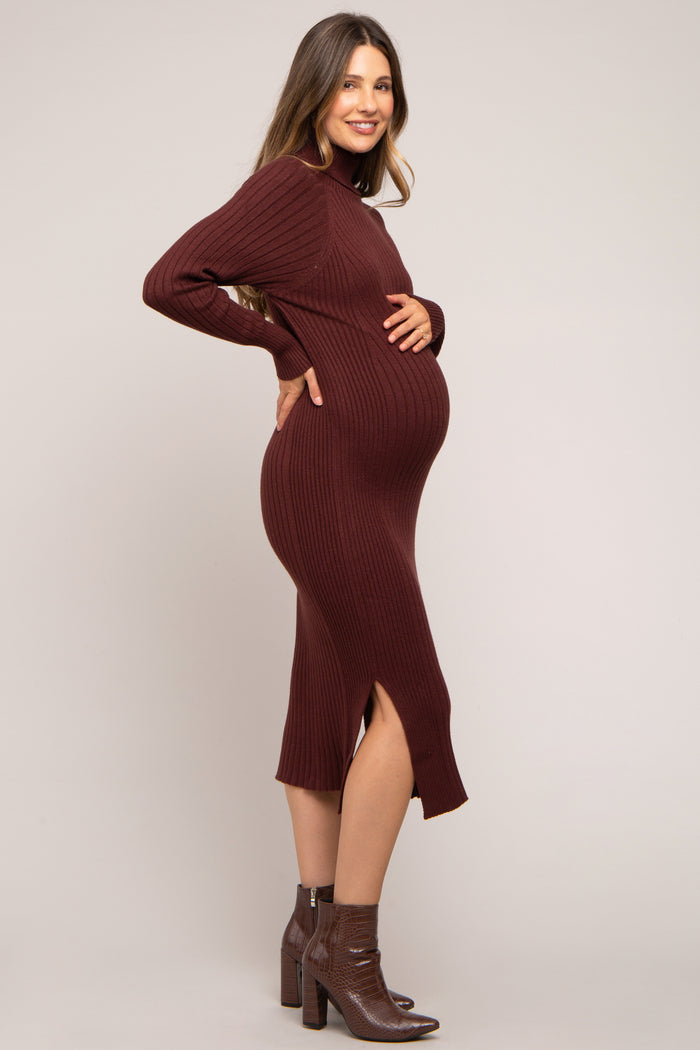 woman wearing a burgundy ribbed maternity dress with side slits and a visible baby bump