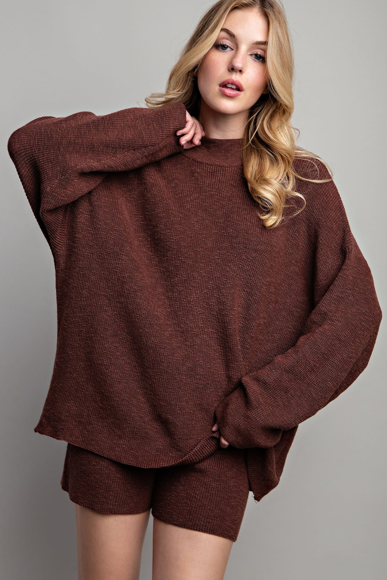 woman wearing a brown oversized knit sweater with matching shorts
