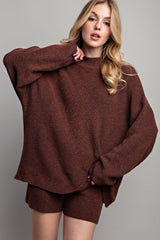 woman wearing a brown oversized knit sweater with matching shorts