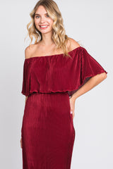 woman wearing a burgundy off-the-shoulder ribbed maxi dress with a loose flutter sleeve