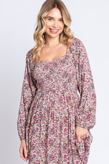 woman wearing a floral print long sleeve maxi dress with a square neckline and smocked bodice