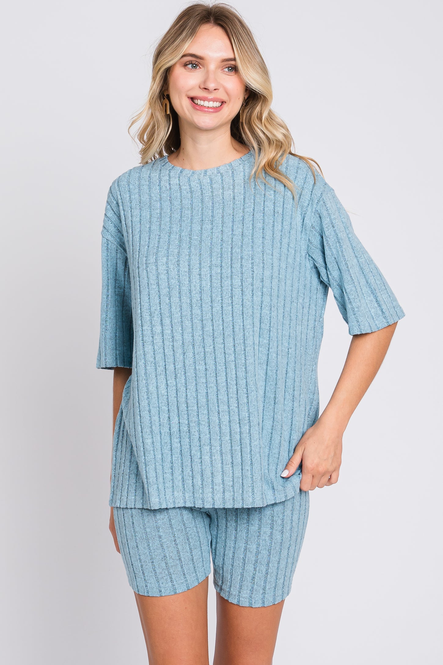 woman wearing a light blue ribbed short sleeve top and matching shorts
