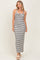 woman wearing a black and white striped maxi dress with a halter neckline and twist front detail