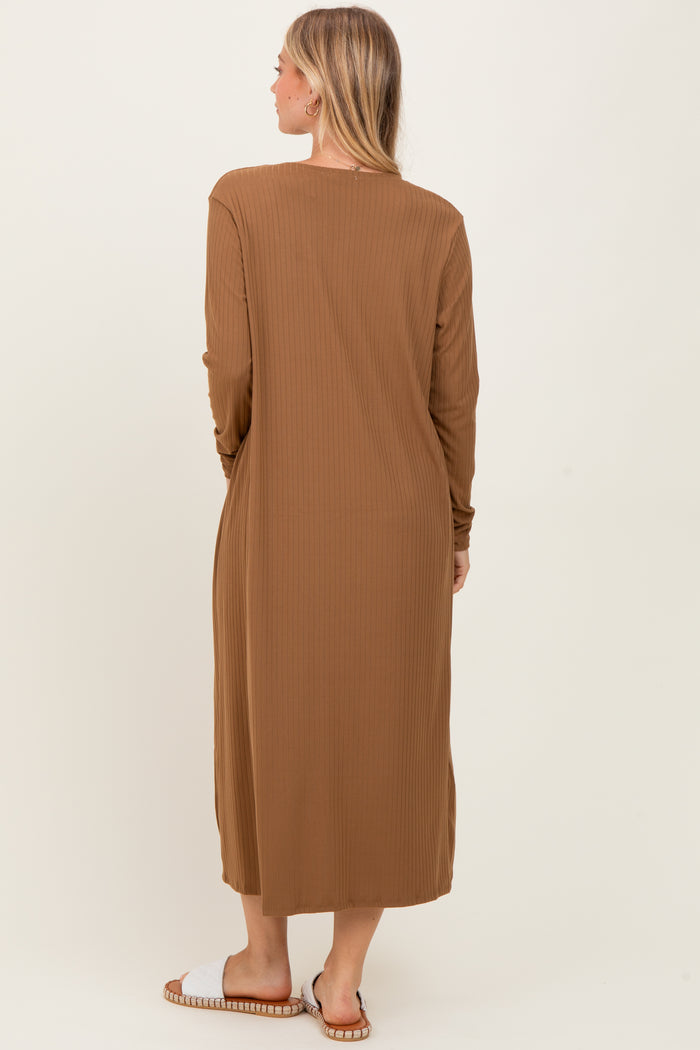 woman wearing a brown ribbed long sleeve maxi dress, viewed from the back