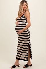 woman wearing a black and cream striped maternity midi dress with side slit, showing her baby bump