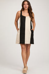 woman wearing a striped black and cream maternity dress with pockets and a casual fit
