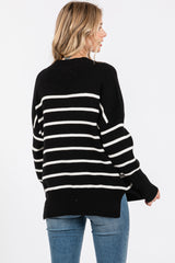 woman wearing a black and white striped oversized sweater with a relaxed fit, seen from the back