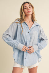 woman wearing a blue and white striped oversized button-up shirt with front pocket and long sleeves