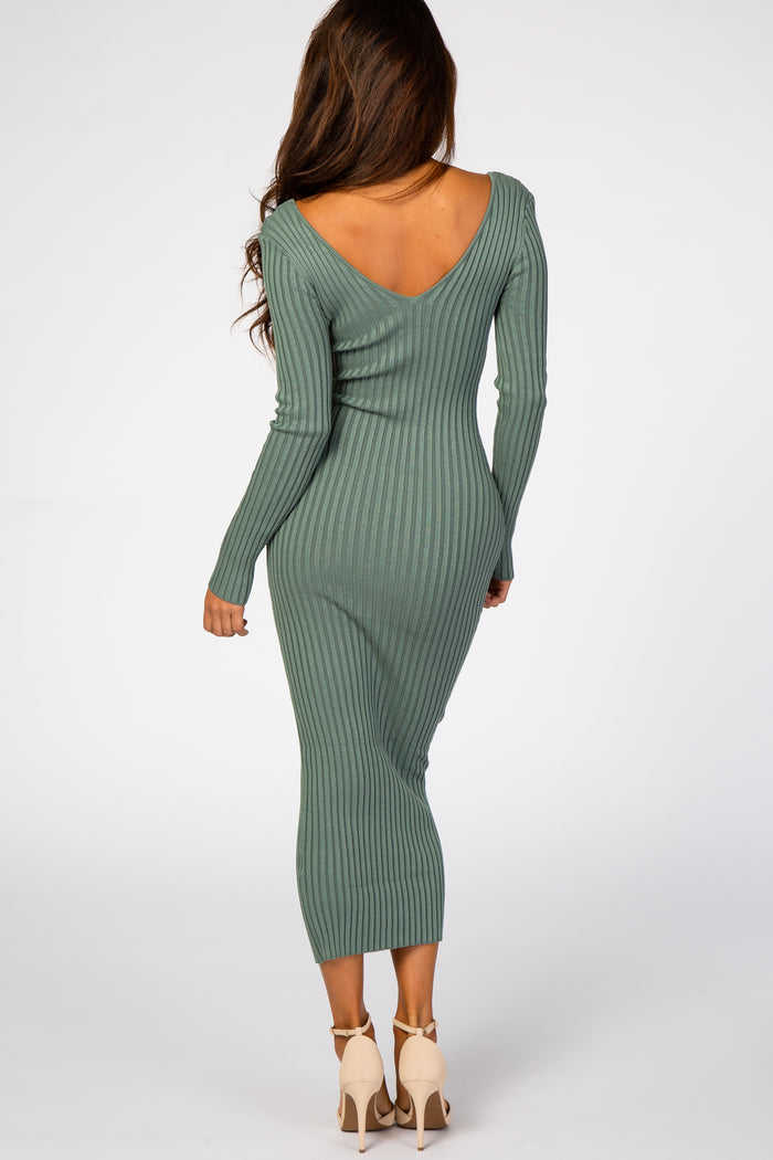 woman wearing a green ribbed long sleeve bodycon dress with a deep v-back and fitted silhouette