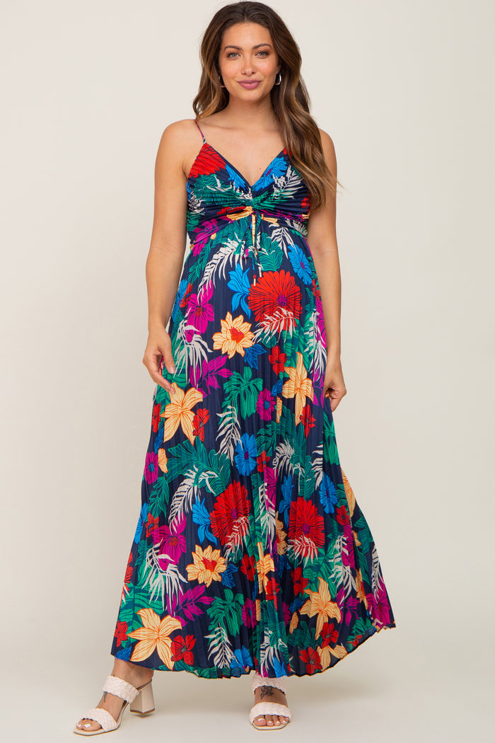 woman wearing a colorful floral maternity maxi dress with a tie detail and a visible baby bump