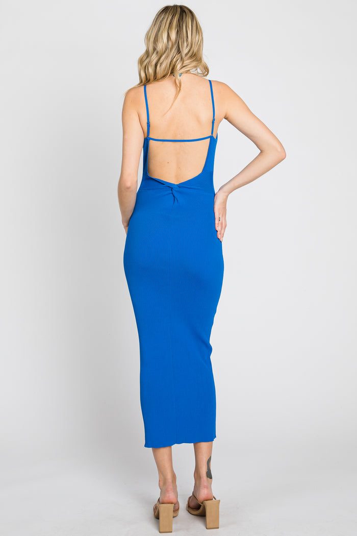woman wearing a blue ribbed midi dress with a back cutout and spaghetti straps